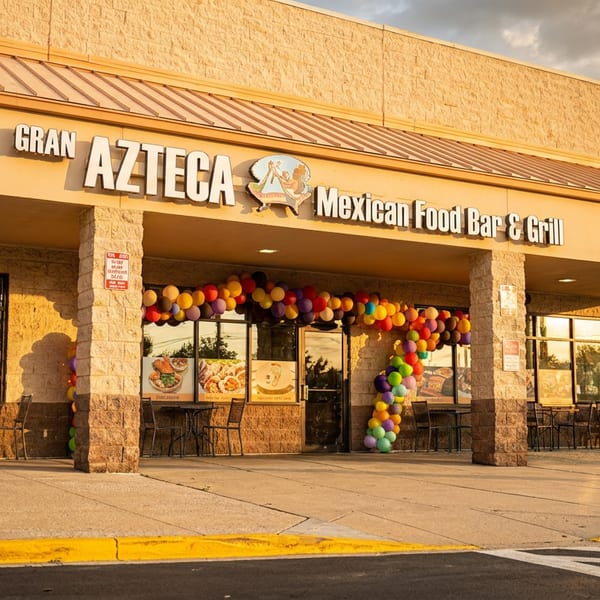 Exterior of Gran Azteca Mexican Food Bar & Grill with colorful balloons and outdoor seating.